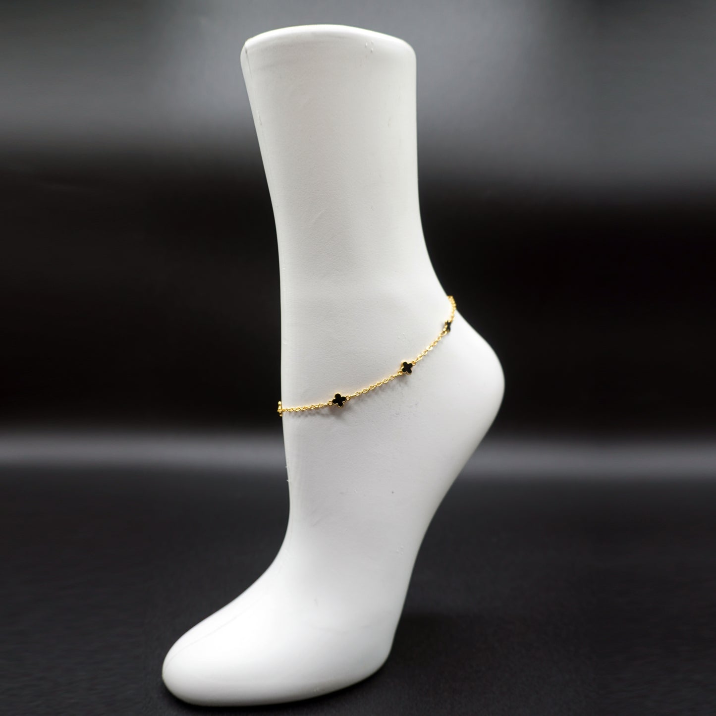 Ankle bracelet featuring small black cross charms
