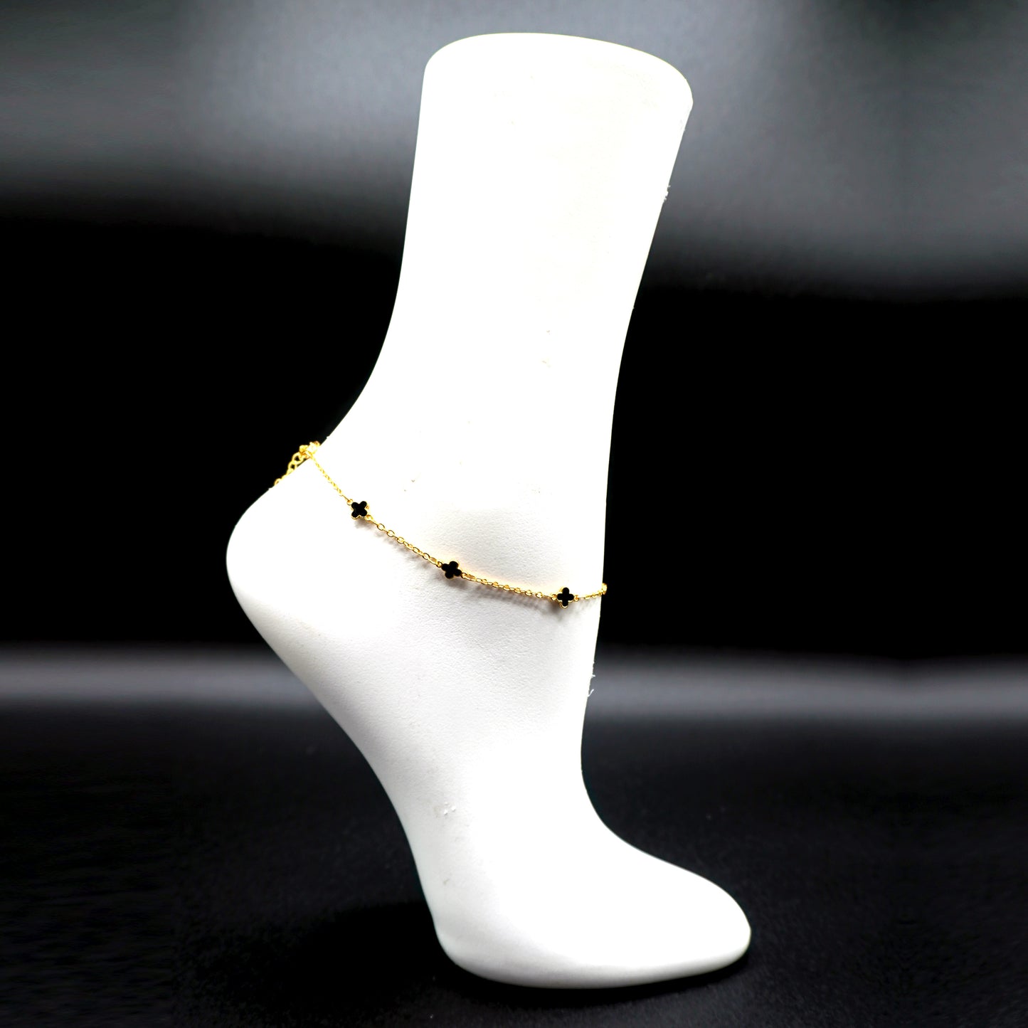 Ankle bracelet featuring small black cross charms